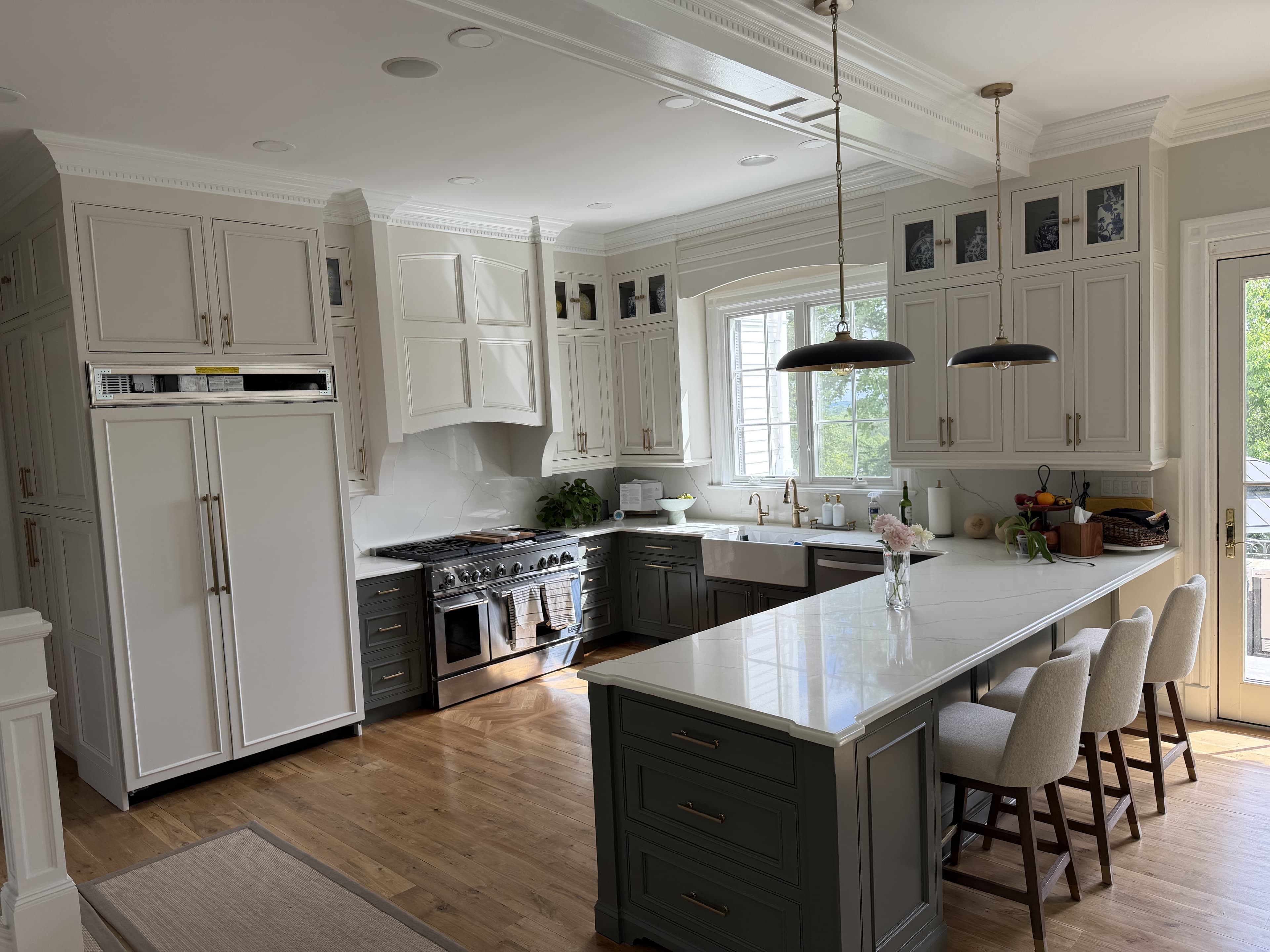 Custom kitchen with two-tone cabinetry, coffered ceiling and Sub-Zero appliances