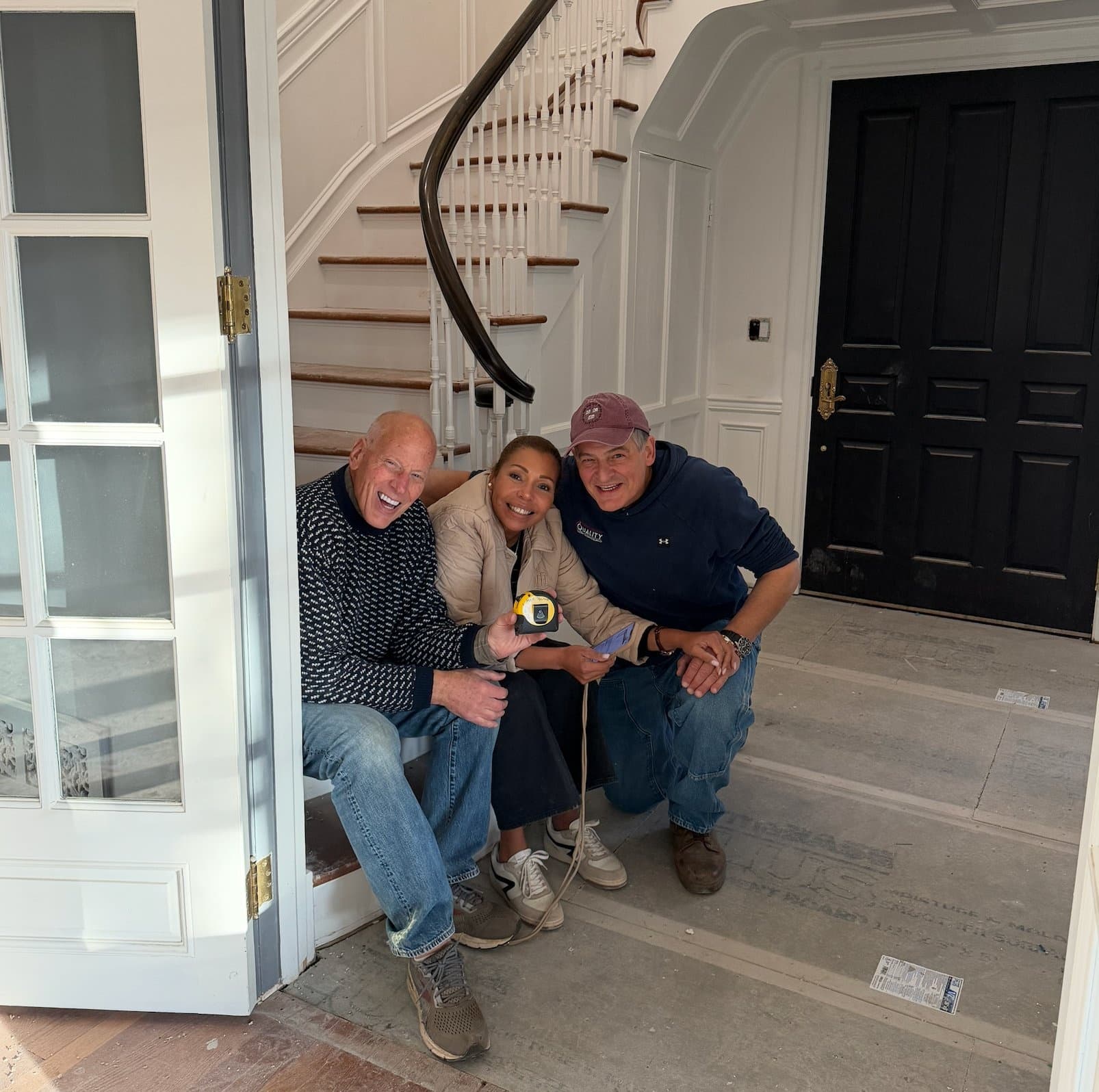 Ricardo Bottino with clients Max and family on the steps of a home under construction